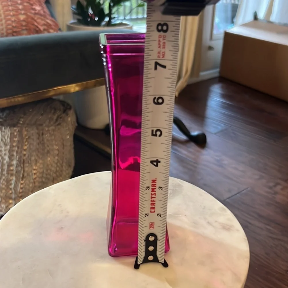 Pink glass narrow 7.5” tall 2.25” wide at widest part top & bottom, 1.75” middle
